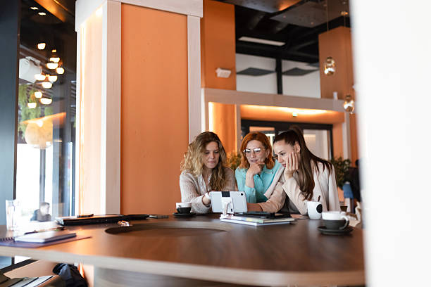 istock Businesswomen collaborating in a modern office space while discussing ideas and reviewing documents together 2217643972