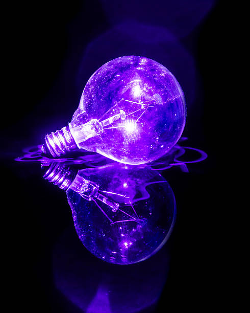 istock Glowing Glass Lightbulb with purple laser lighting it 2217644524