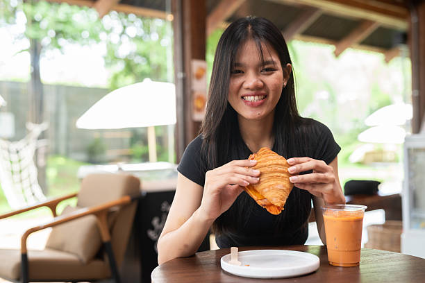 istock Young beautiful Asian woman in cafe 2217644639