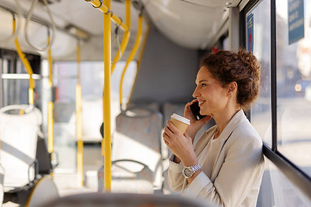 istock Beautiful Woman Talking on Cell Phone While Riding City Bus 2217644963