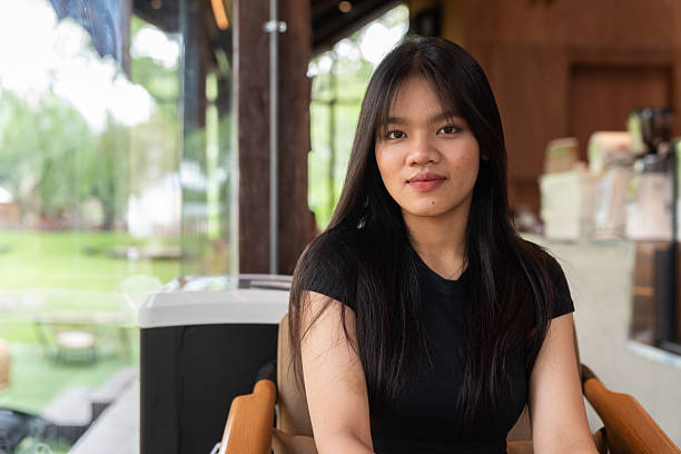 istock Young beautiful Asian woman in cafe 2217644988