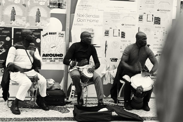 Lisbon, Portugal - November 30, 2024: A trio of street musicians perform at the Rua Augusta street in Lisbon downtown.