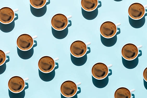 istock Pattern made of cup of coffee on blue background 2217645370