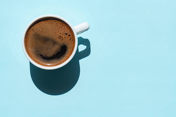 Directly Above View Of Coffee In Cup On Blue Background