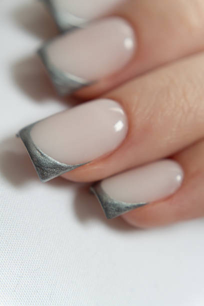 istock Modern metallic French manicure on structured square nails — glossy silver tips paired with a smooth milky base. 2217646526