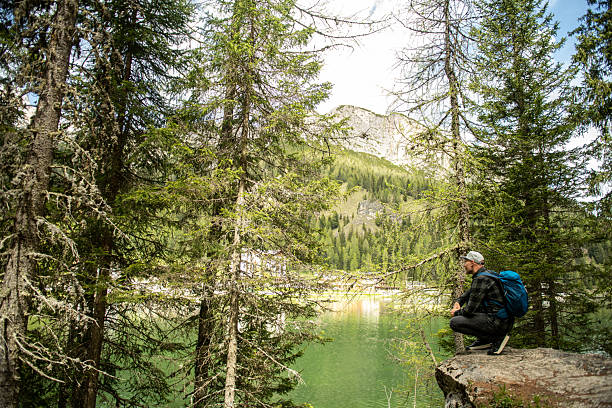 Man hiking the mountain trails in Dolomites, Lake Misurina, Tre Cime, Italy.