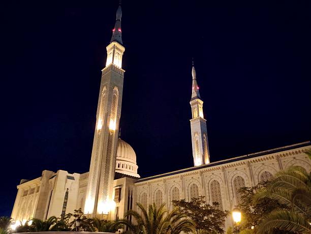 Panoramic night view of the Emir Abdelkader Mosque in Constantine, Algeria. With its towering minarets and elegant domes, the mosque stands as a symbol of Islamic architecture and national pride