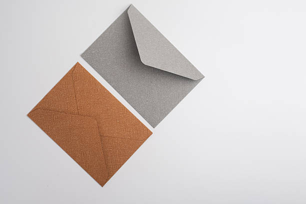 istock Paper envelopes on a light background. New mail, write a message. Send and receive mail. Postal delivery service. Empty envelope, empty space. Communication with people, paperwork. Envelope close-up 2217649124