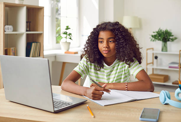istock Smiling African American Girl studying with laptop computer 2217650316