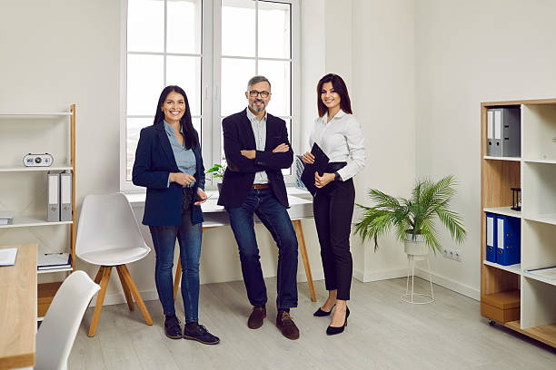 istock Successful business team standing together looking at camera and smiling 2217650512