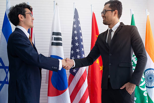 istock Businessmen from two nationalities expressed their gratitude by shaking hands 2217651668