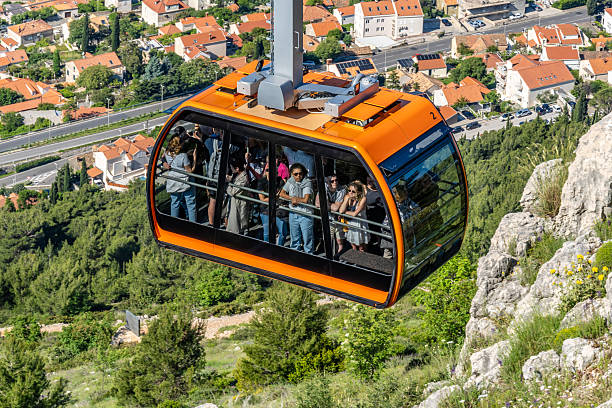 Dubrovnik, Croatia. 10 May 2025. People ride a cable car high above Dubrovnik