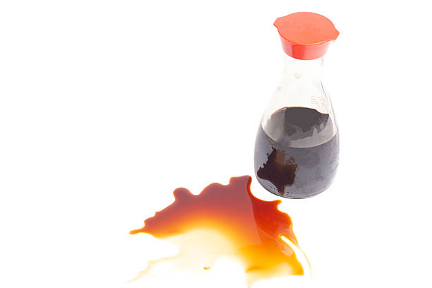 istock splashes of soy sauce with a bottle isolated on white, top view 2217652748