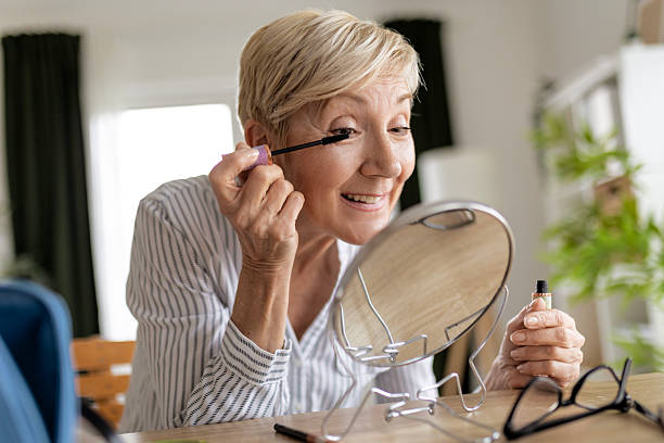 istock Mature Woman Putting on Mascara with Confidence 2217653974