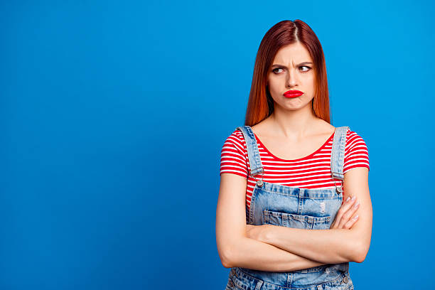 istock Photo of confident upset young lady dressed denim clothes arms folded looking empty space isolated blue color background 2217654541