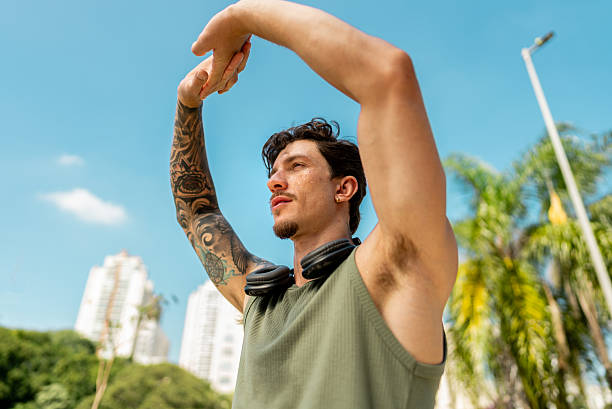 istock Young man stretching outdoors 2217657079