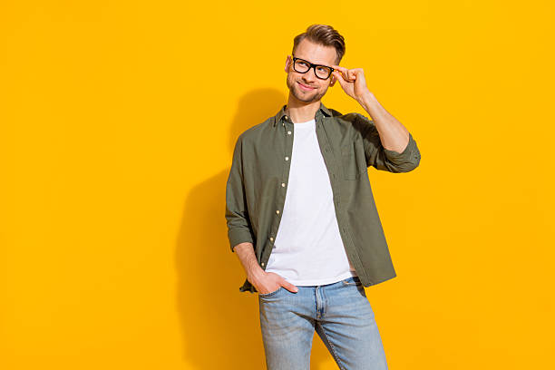 istock Portrait of attractive cheerful minded guy touching specs thinking copy space isolated over bright yellow color background 2217660837
