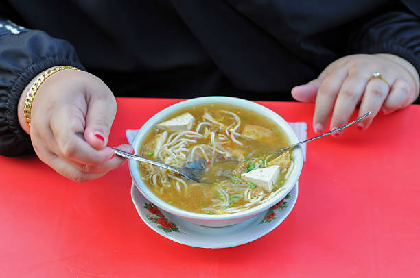 woman eat miso on red table