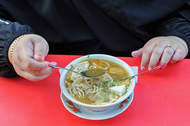 woman eat miso on red table