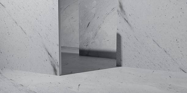 Minimal concrete room with geometric walls and soft shadows, offering a modern, abstract background ideal for design mockups, architecture themes, or creative visual concepts.