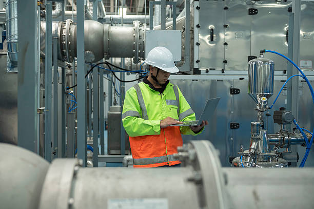 istock Asian Engineer Performing Pipe System Inspection in Modern Industrial Facility 2217664249