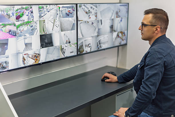 istock Security guard monitoring cctv cameras on multiple monitors 2217666065