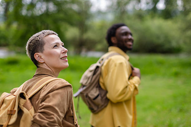 istock Two friends enjoying a hiking adventure in a lush forest setting under a vibrant sky 2217669175