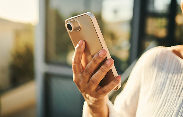 istock Female Hand Holding Smartphone in Modern Setting 2217670269