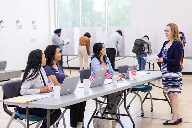 istock Election Workers Assisting Voters at Polling Place 2217675228