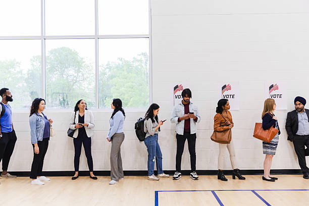 istock Multiracial Voters Waiting in Line at Polling Place 2217675260