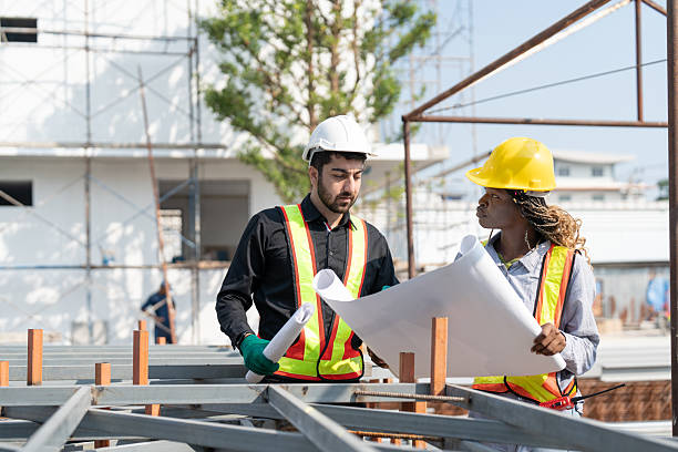 istock Civil engineer and architect with blueprint discussing inspecting structure building project at construction site. 2217676393