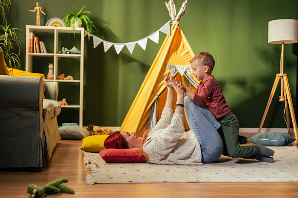 istock Mother and son playing together on the floor in cozy playroom 2217683036