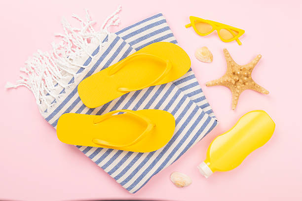istock Beach towel with summer accessories on color background, top view 2217687124