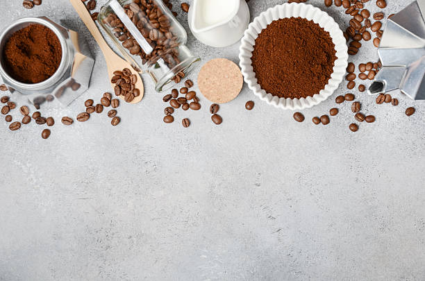 istock Coffee preparation scene featuring ground coffee, beans, milk, and tools arranged on a textured surface, creating an inviting atmosphere for enthusiasts 2217688315