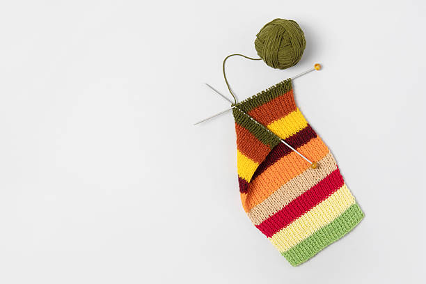istock Ball of thread with knitting needles and knitted fabric 2217688375