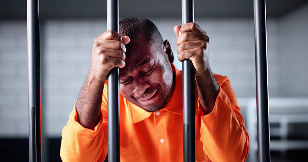 istock Sad African American Man Behind Bars 2217690016