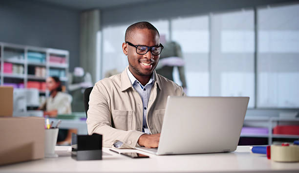istock African Fashion Designer Using Laptop 2217690025