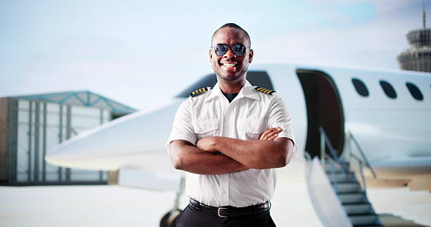 istock Young African American Man Smiles As Private Jet Pilot 2217690048
