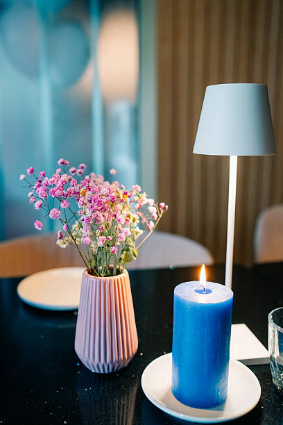 istock Beautifully arranged table setting with vibrant flowers and blue candle providing a serene atmosphere 2217690408