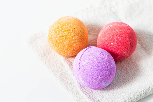 istock Colorful bath bombs resting on a soft towel ready for a relaxing bath experience 2217693664