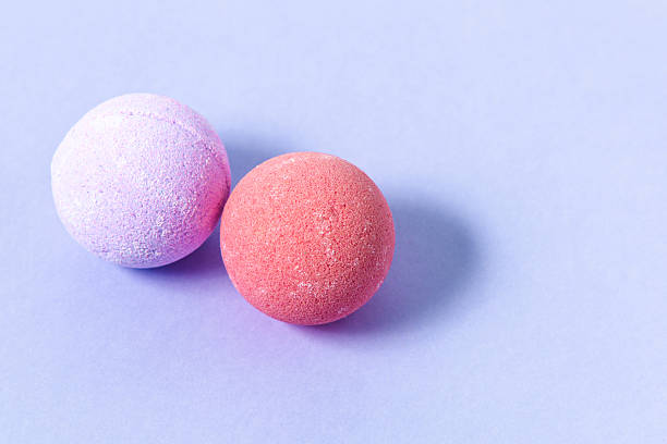 istock Colorful bath bombs resting on a soft purple surface in a calm and relaxing setting 2217693665