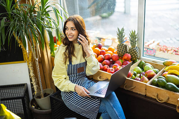 istock Beautiful female grocer checking stock and placing orders 2217694823