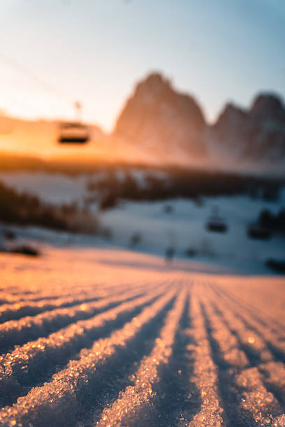 Ski run, mountains and chairlift at sunset, Dolomites