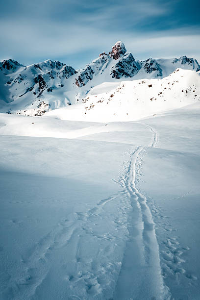 istock Ski tracks and snowcapped mountain 2217695981