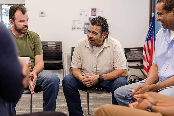 istock Group therapy session: men discussing mental health and emotional support 2217696648