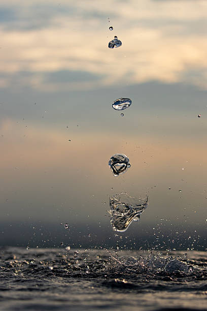 istock Drops of water forming different shapes as they fall. 2217696877