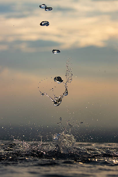 istock Drops of water forming different shapes as they fall. 2217696924