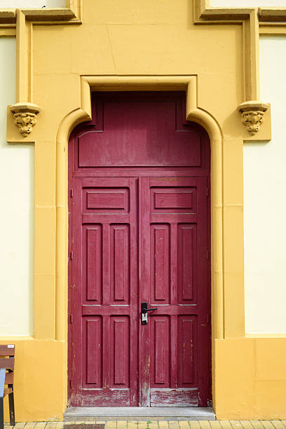 istock Garnet door in yellow facade 2217697558