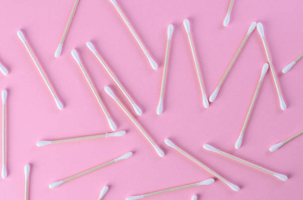 istock Scattered cotton swabs on pink background in chaotic arrangement 2217697639