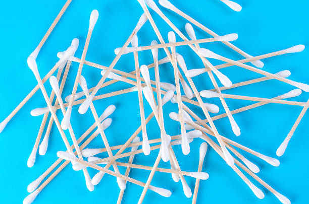 istock Cotton swabs scattered on blue background in chaotic composition 2217697684